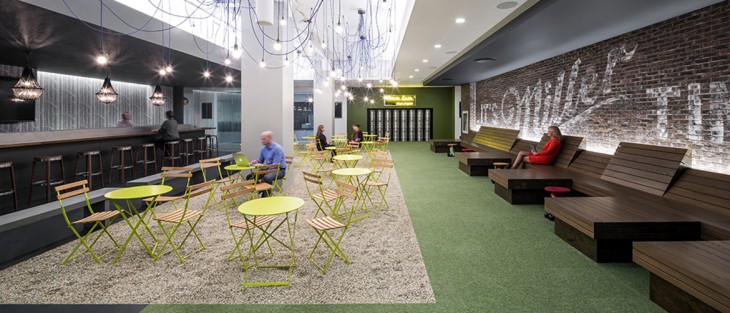 In the beer garden at media company Initiative, Ted Moudis Associates applied graffiti over a cost effective stone veneer. Photography: by Magda Biernat