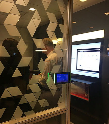 Shown at Steelcase, Designtex’s new, unnamed clocking film conceals digital screens in a glass-walled roomed from exterior view.